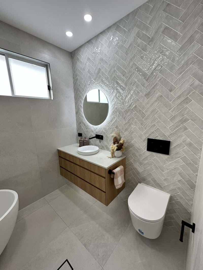 Bathroom renovation with gloss herringbone feature wall by ASP Build & Co, Adelaide