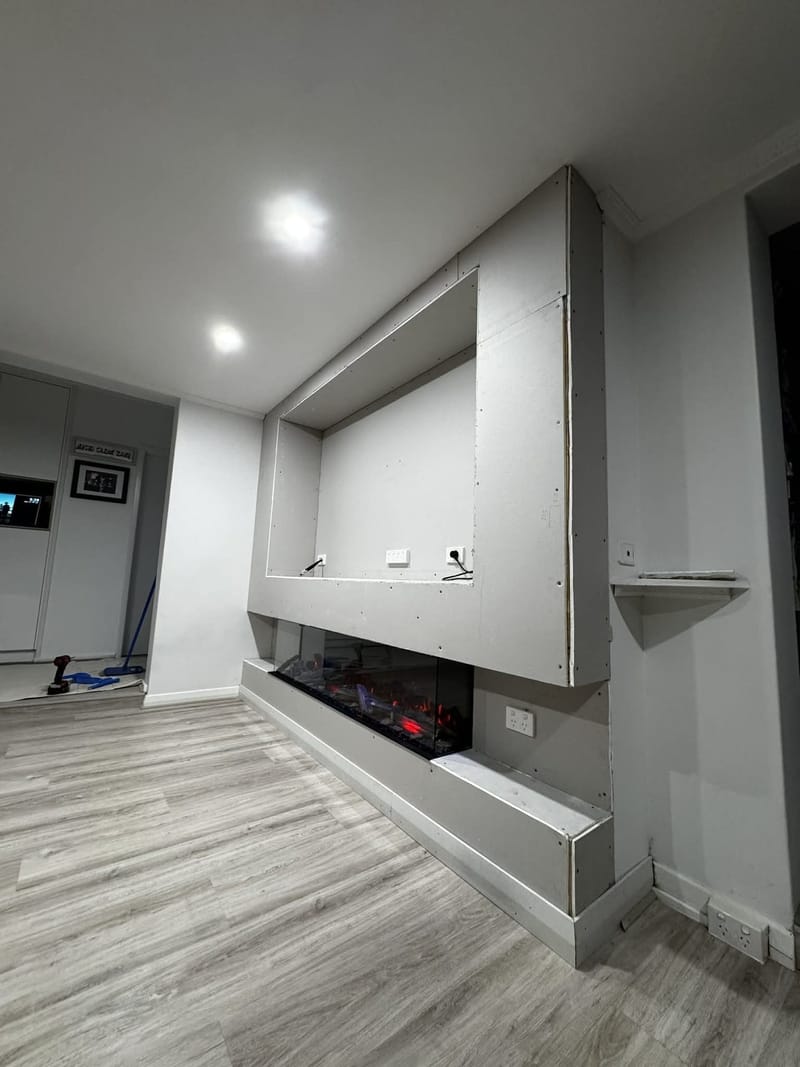 Custom media wall and fireplace by ASP Build & Co