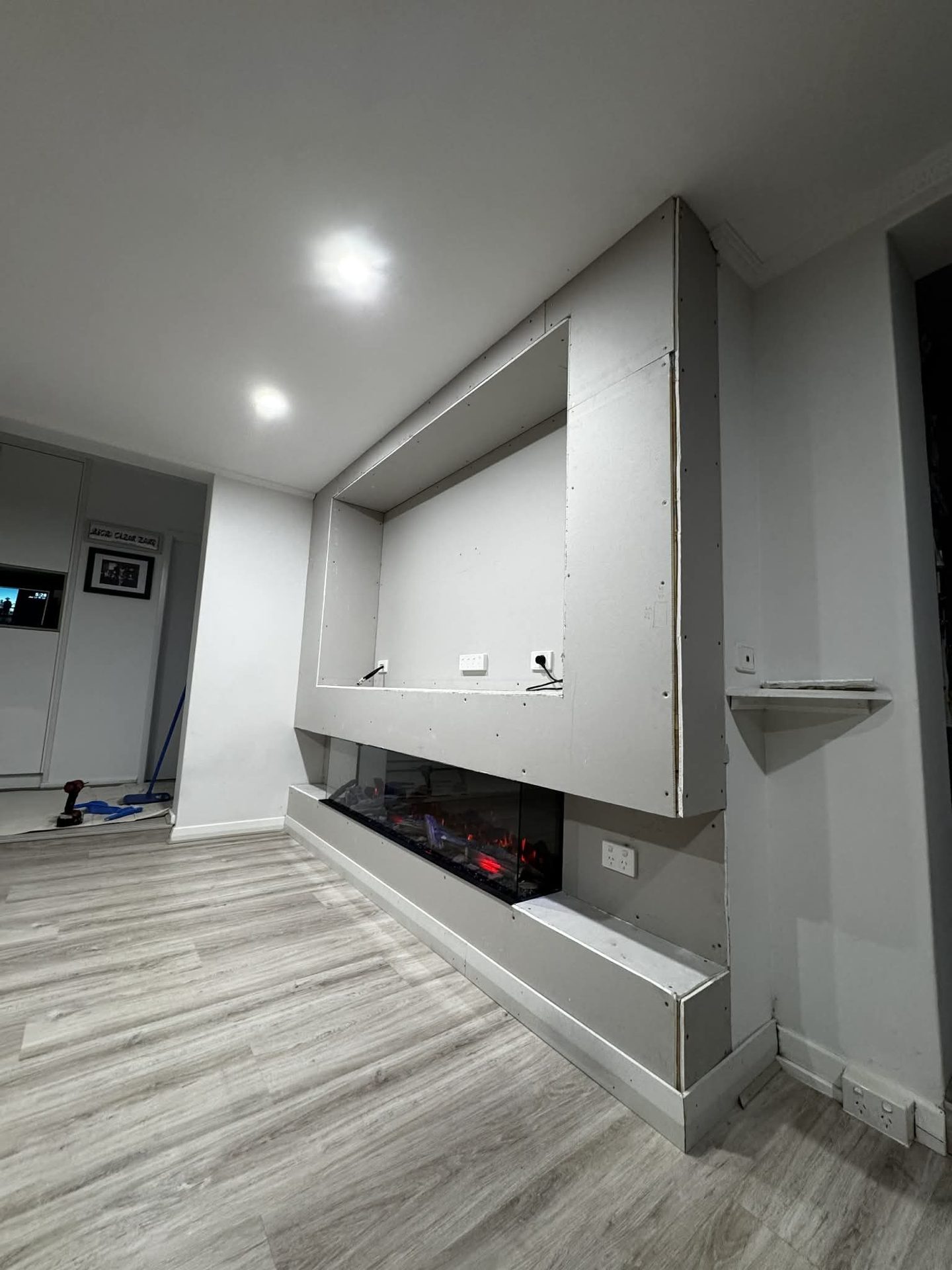 Custom media wall and fireplace by ASP Build & Co