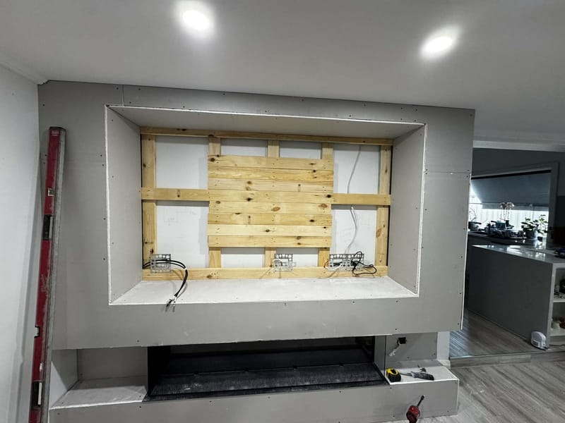 Media wall with integrated fireplace by ASP Build & Co