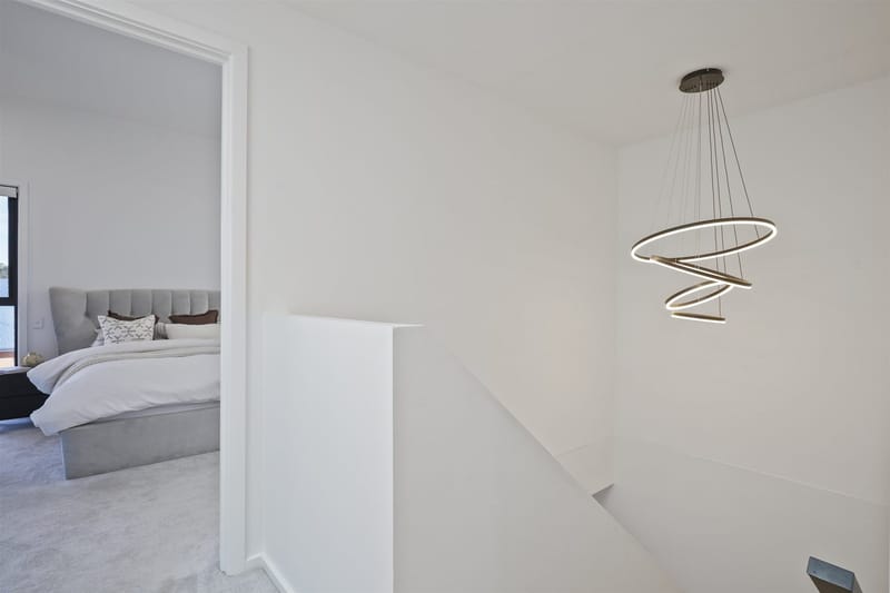 Upstairs landing with spiral LED pendant above the stairwell in a Riverlea Park home built by ASP Build & Co