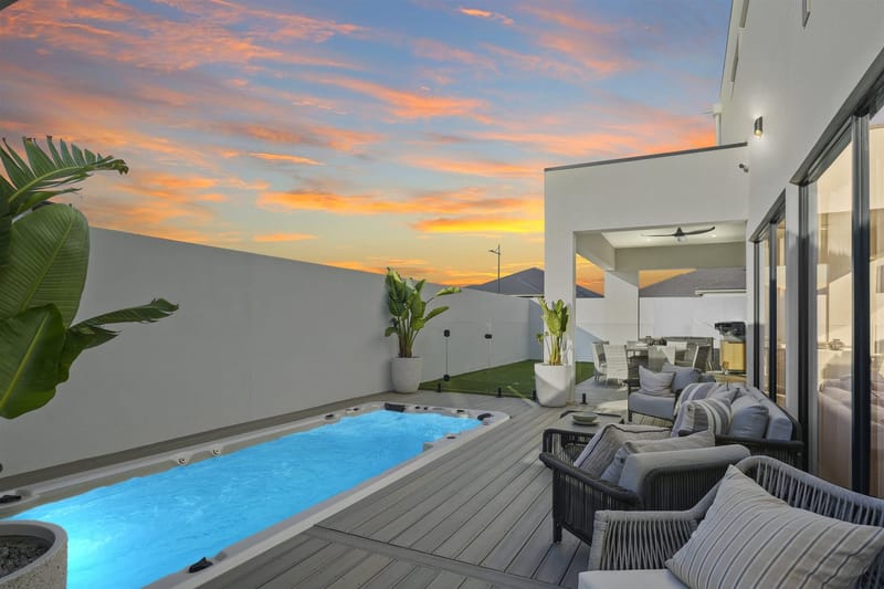 Custom home at twilight in Riverlea Park by ASP Build & Co