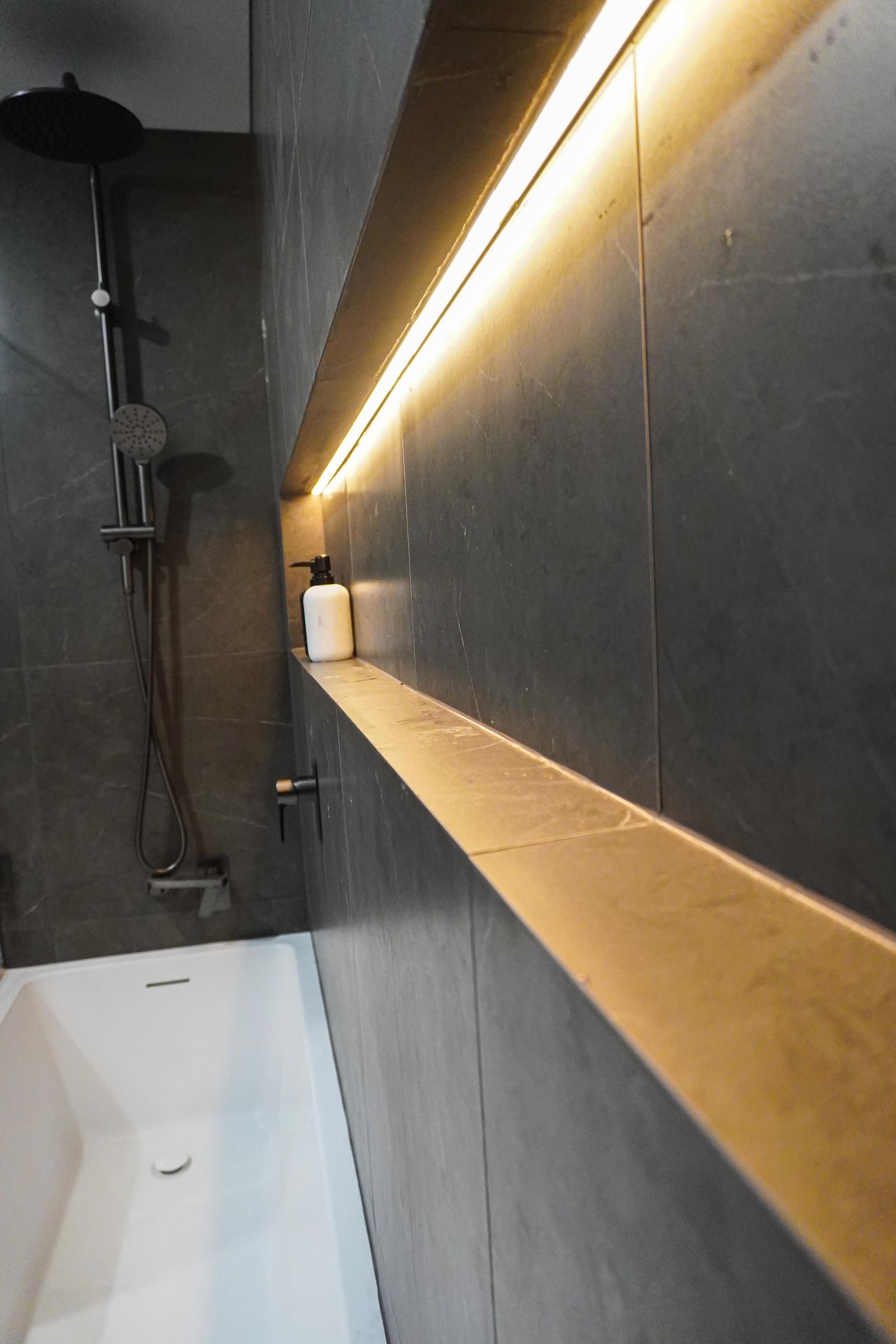 LED-lit niche ledge and black rail shower in a renovated Modbury bathroom