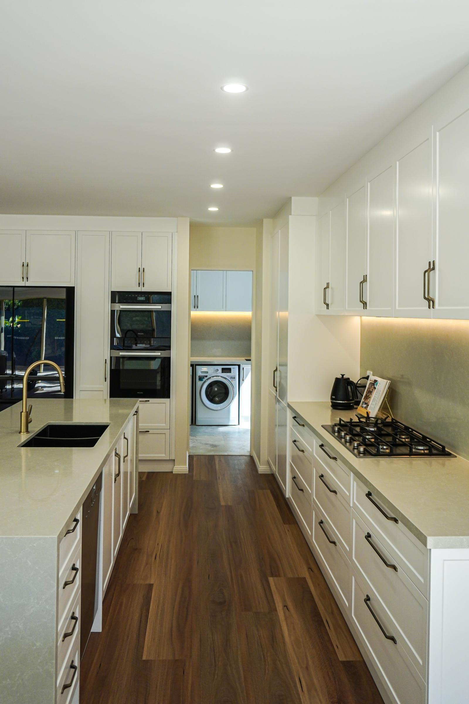 Galley view along the stone island and cooktop run through to the laundry, Torrens Park kitchen renovation