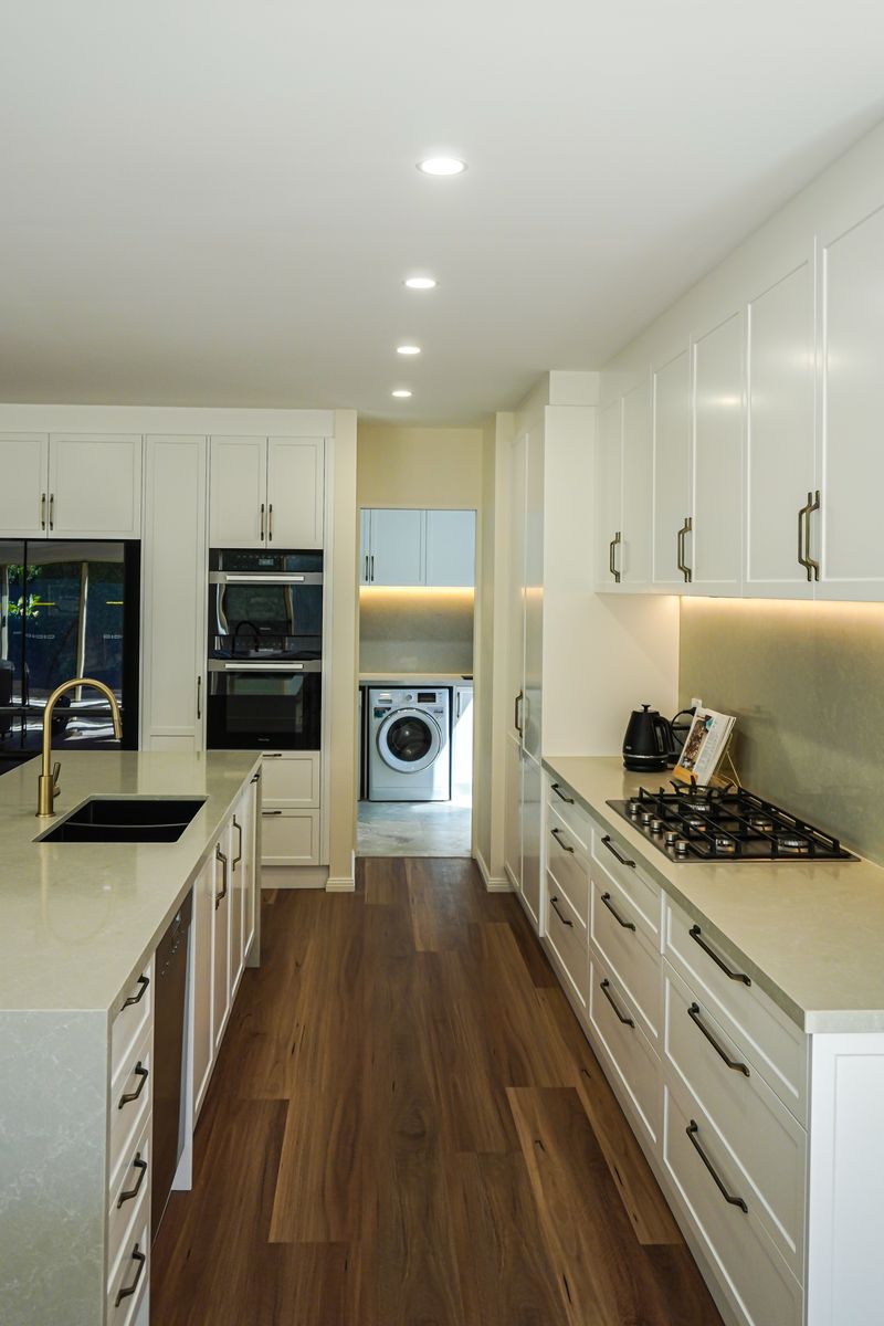 View along the island and cooktop run through to the laundry in a Torrens Park kitchen renovation