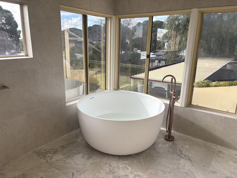 Round freestanding bath in the window bay of a Torrens Park master ensuite