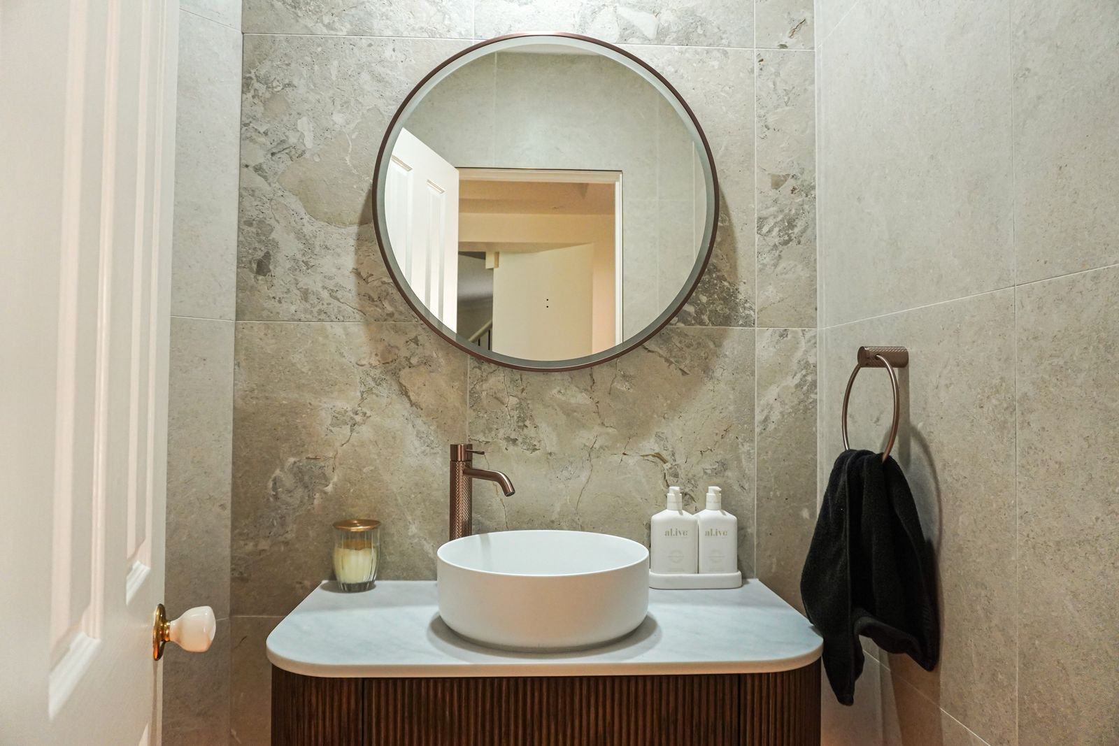 Torrens Park powder room with fluted timber vanity, vessel basin, round mirror and full-height tiles