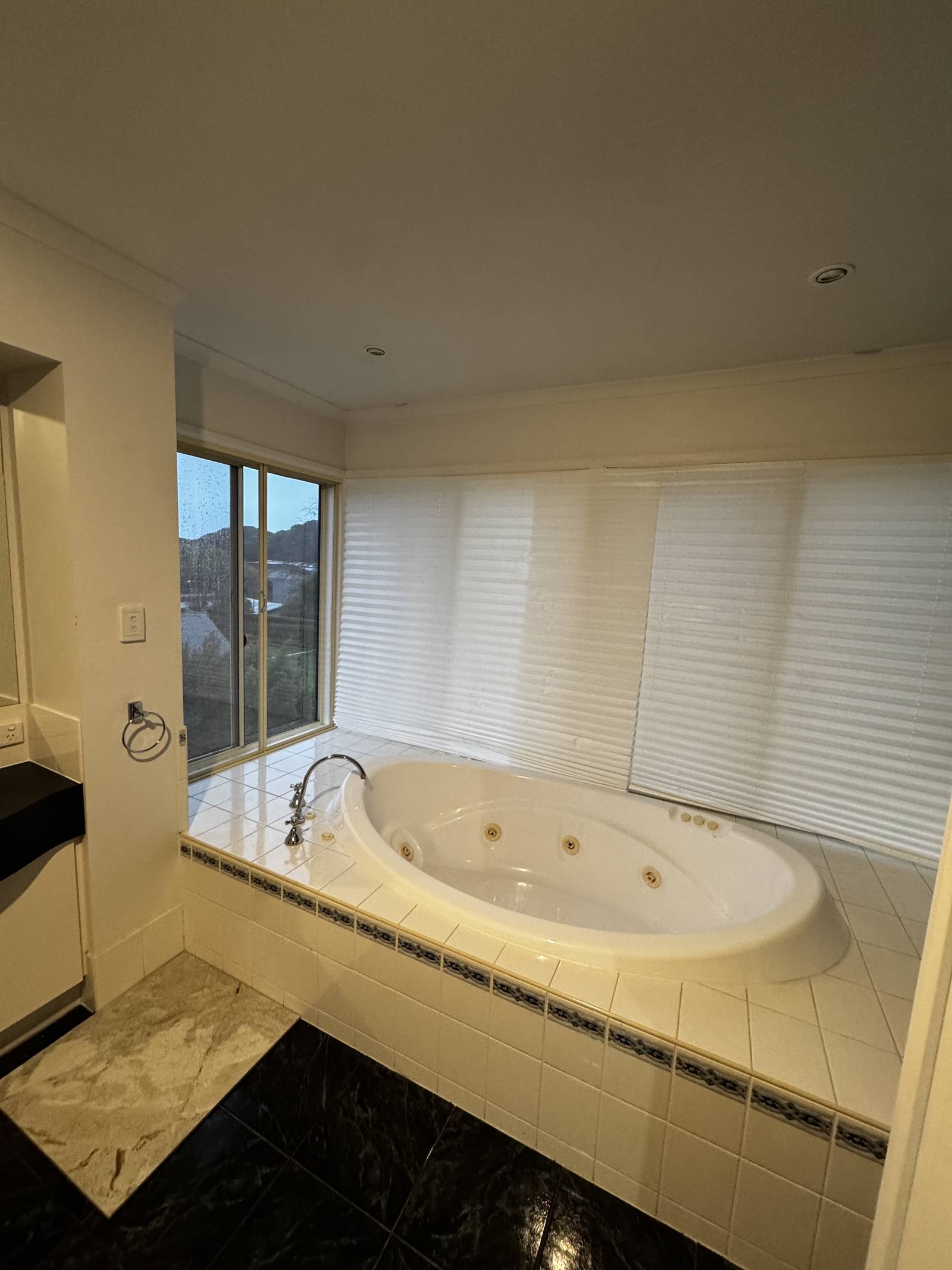 Torrens Park master ensuite before renovation, with a corner spa bath and older tiles